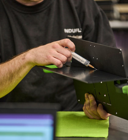 Two parts of black ABS are glued together with a needle with transparent glue.