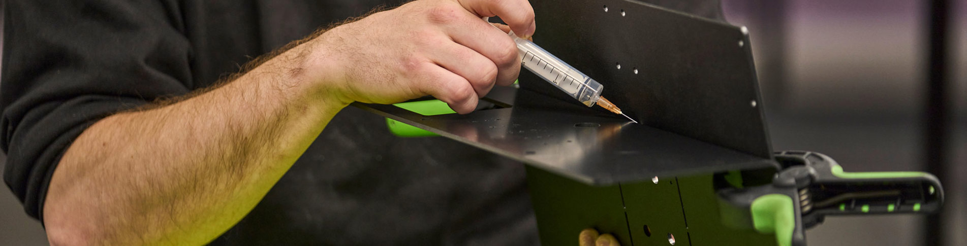 Two parts of black ABS are glued together with a needle with transparent glue.