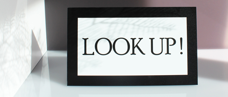 Sign in Dibond with black and white print og the text look up