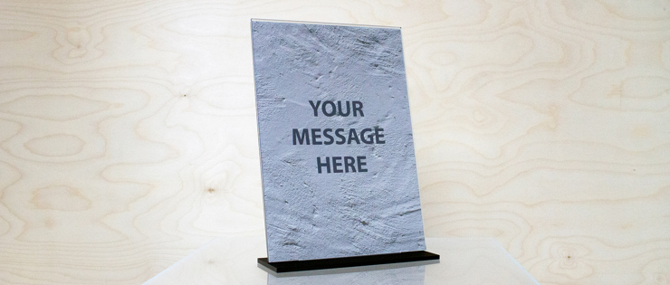 A4 sign holder in clear acrylic with a black foot
