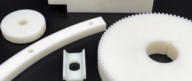 Five various machine parts made from white nylon