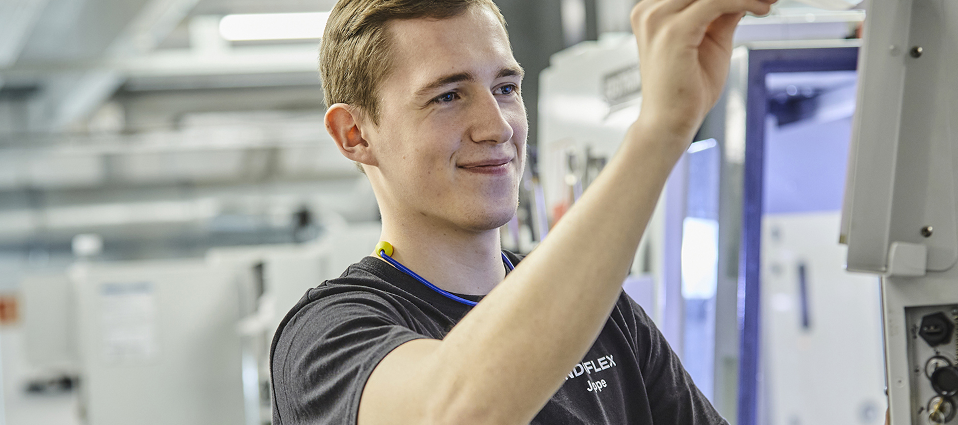 Industry technician at Induflex adjusts CNC milling at the production